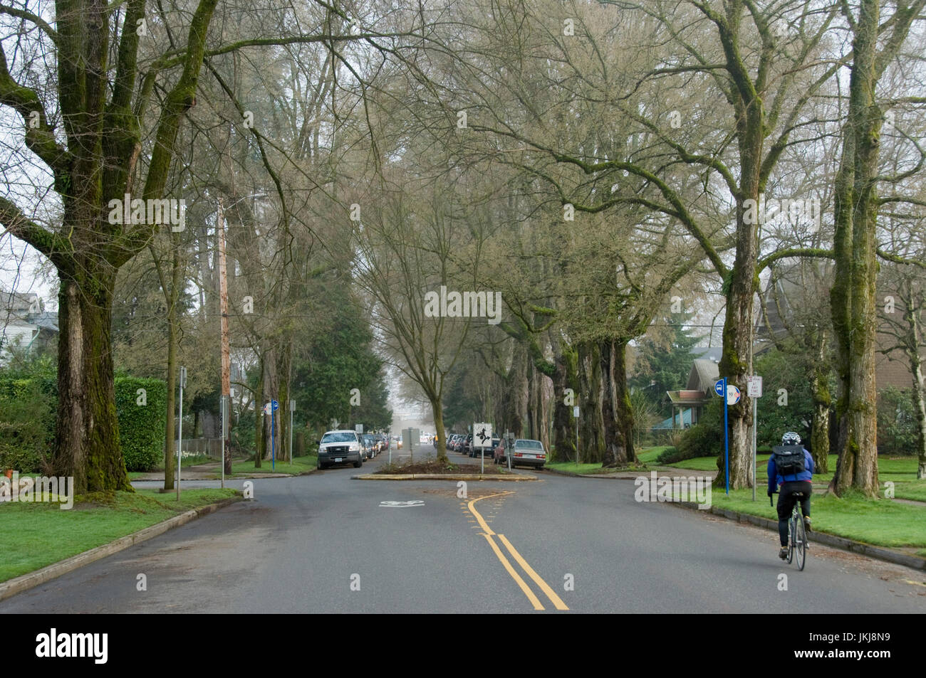 A bicyclist riding through the Ladds Edition neighborhood of Portland, Oregon. Stock Photo