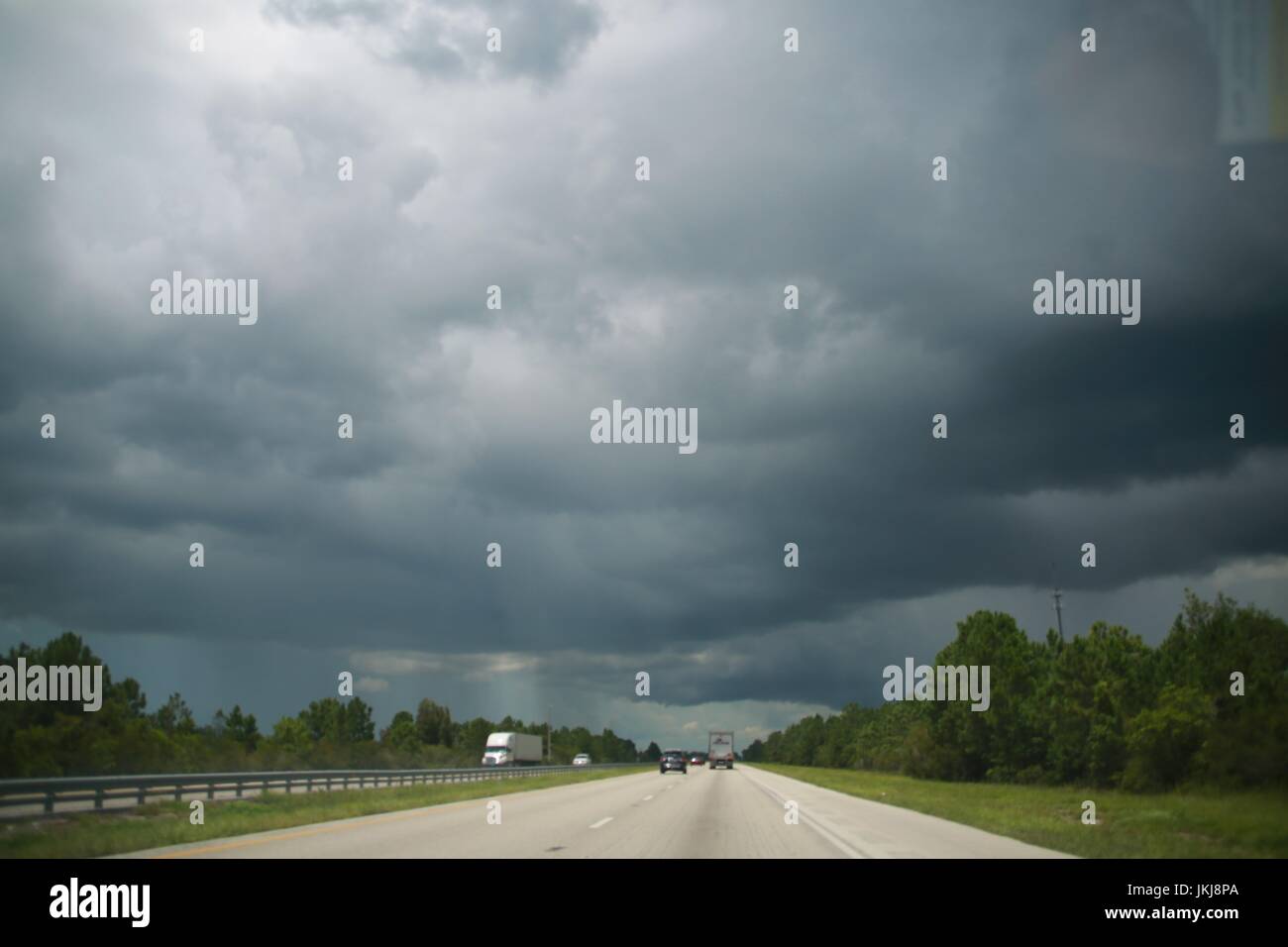 Florida Turnpike Heading Northwest toward Orlando, Florida with Rain Clouds Approaching Stock Photo