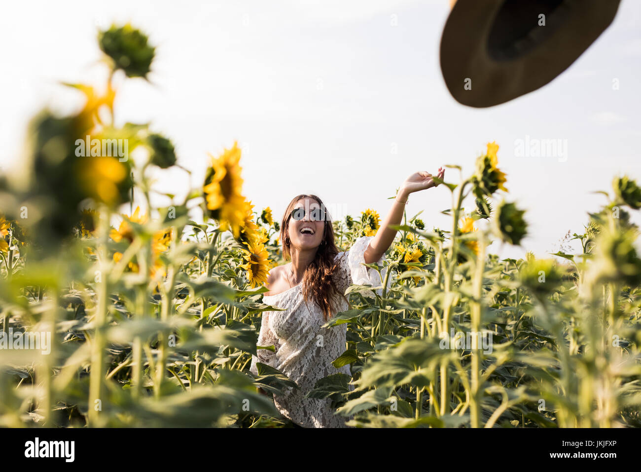 Beautiful Woman in a Sunflower Field Stock Photo - Alamy