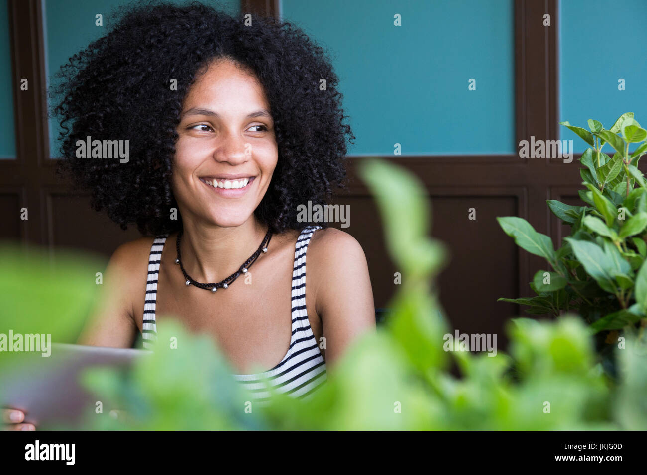 Portrait of happy young woman sitting in a coffee shop Stock Photo - Alamy