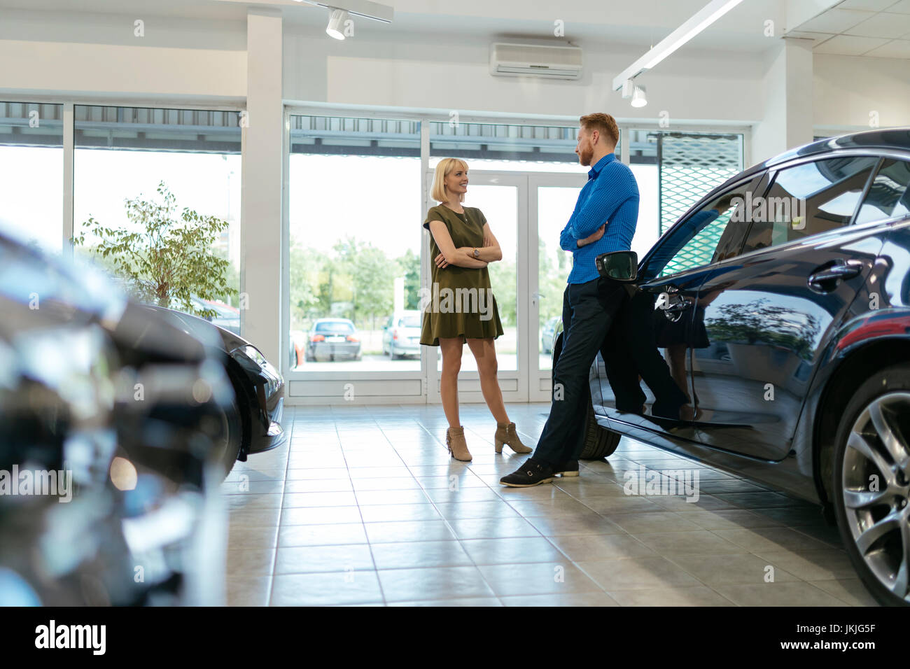 Couple looking for a new car in car dealership Stock Photo Alamy