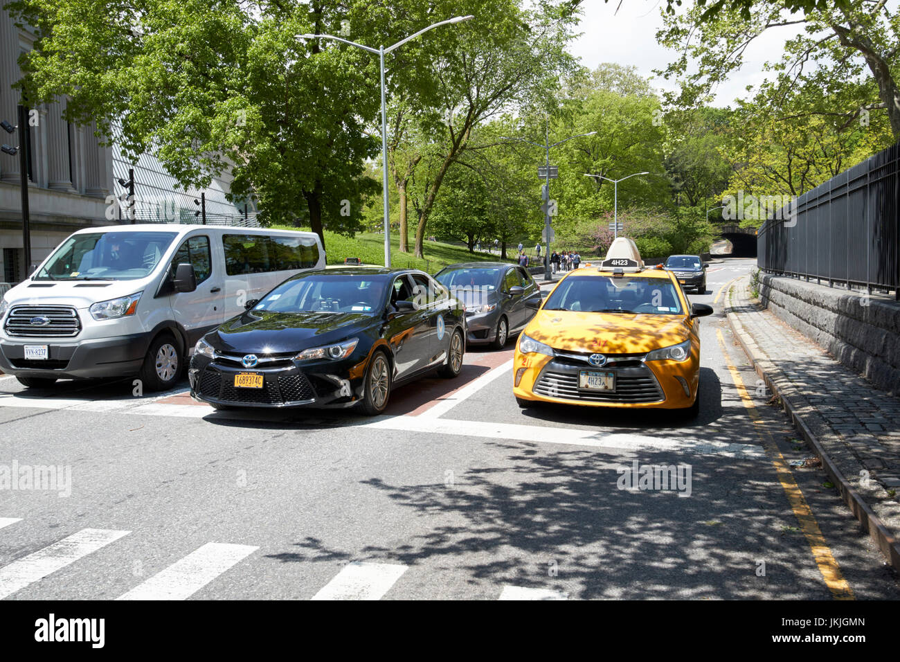 taxi and cars on transverse road through central park west 86th street New York City USA Stock Photo