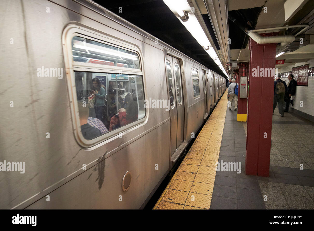 train at platform in subway station sign 34th street penn station New York City USA Stock Photo