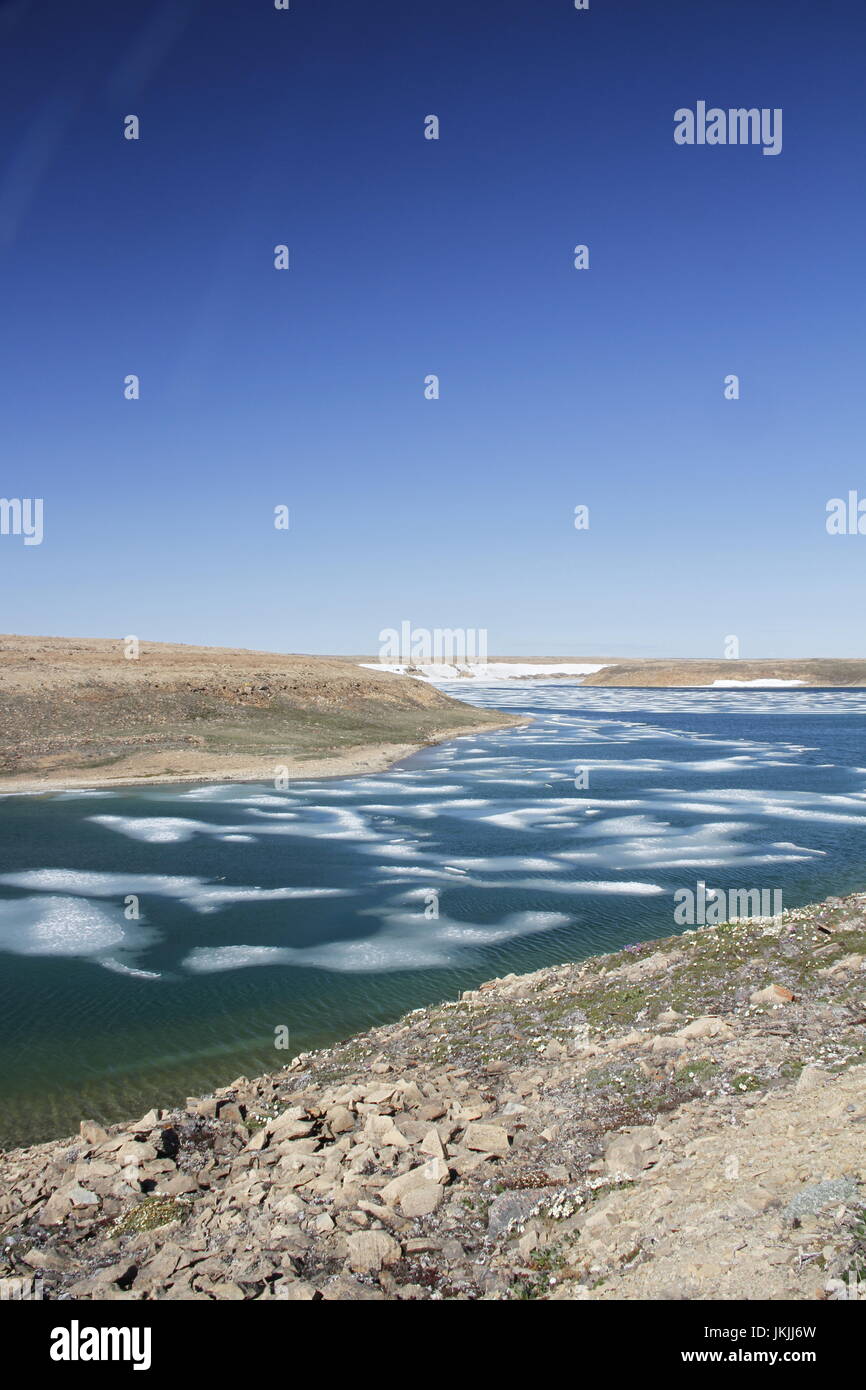 Summer colours in the high arctic with ice in the bay, Cambridge Bay Nunavut Stock Photo