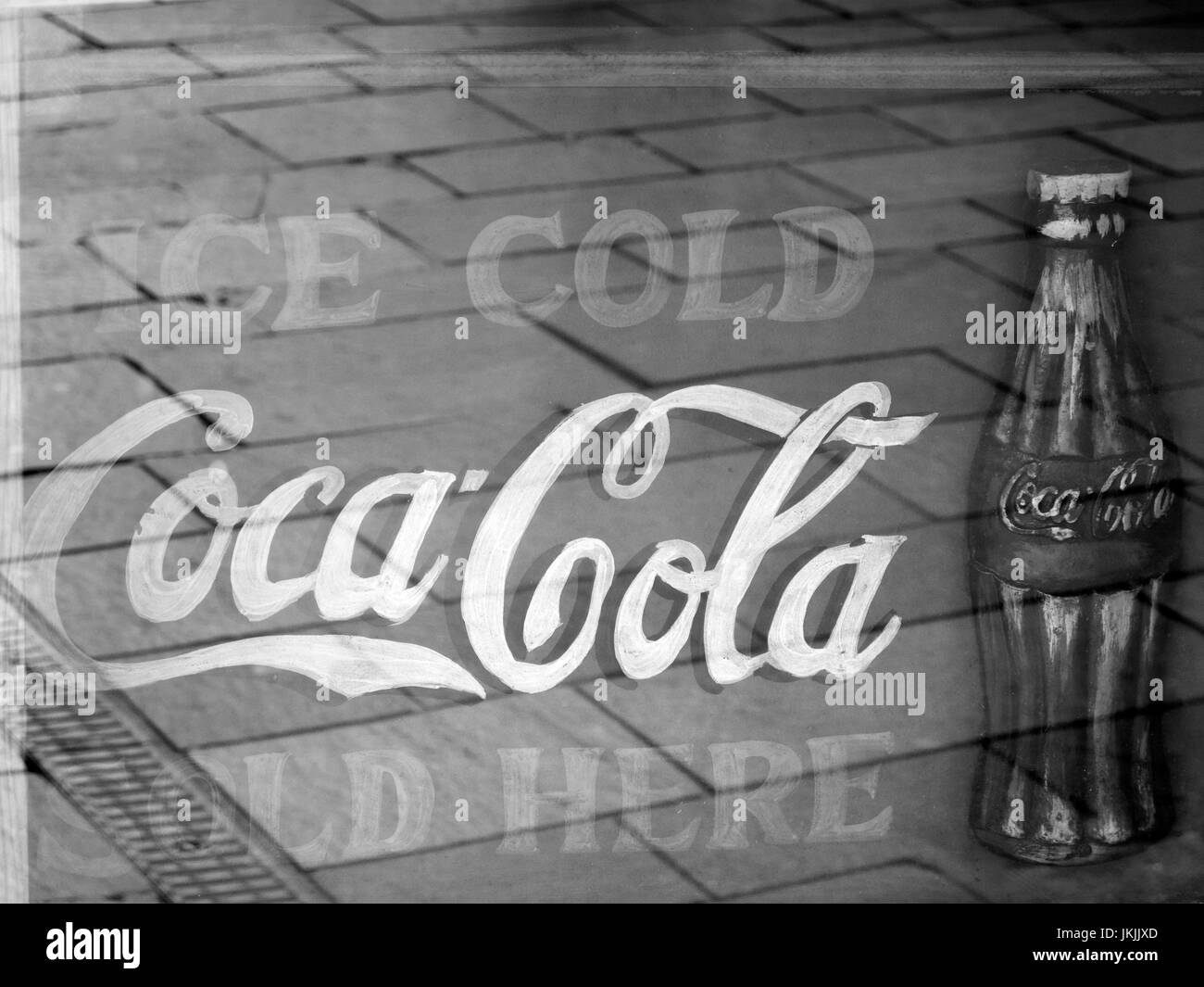 : Faded retro ice cold Coca Cola sold here sign in cafe window, carbonated soft drink invented by John Pemberton Stock Photo