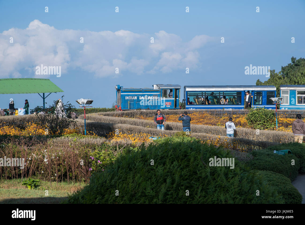 DARJEELING, INDIA - NOVEMBER 27, 2016: Tourists enjoy to visit steam engine hauled DHR Toy Train at Darjeeling. This place is popular for people to wa Stock Photo