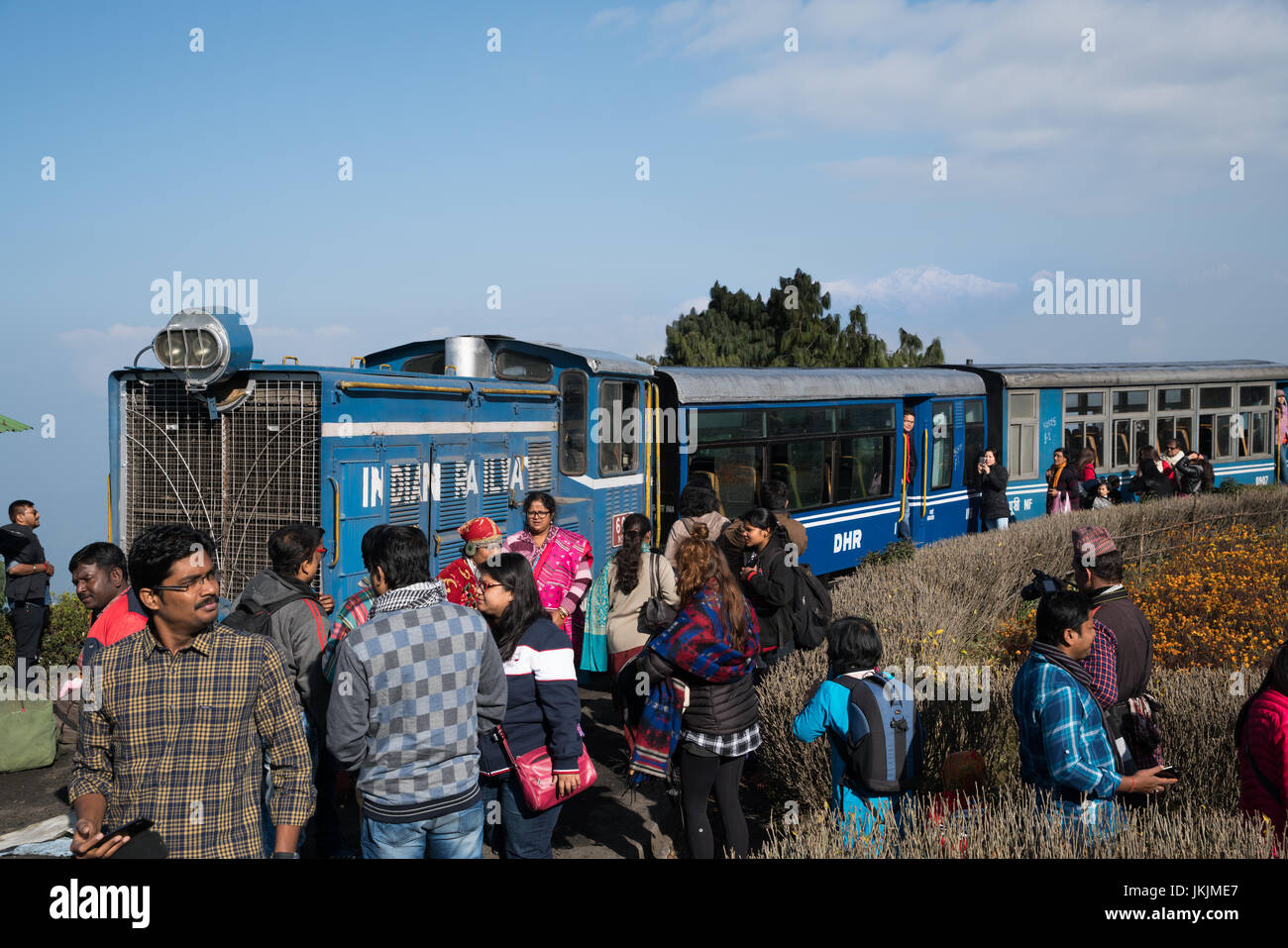 DARJEELING, INDIA - NOVEMBER 27, 2016: Tourists enjoy to visit steam engine hauled DHR Toy Train at Darjeeling. This place is popular for people to wa Stock Photo