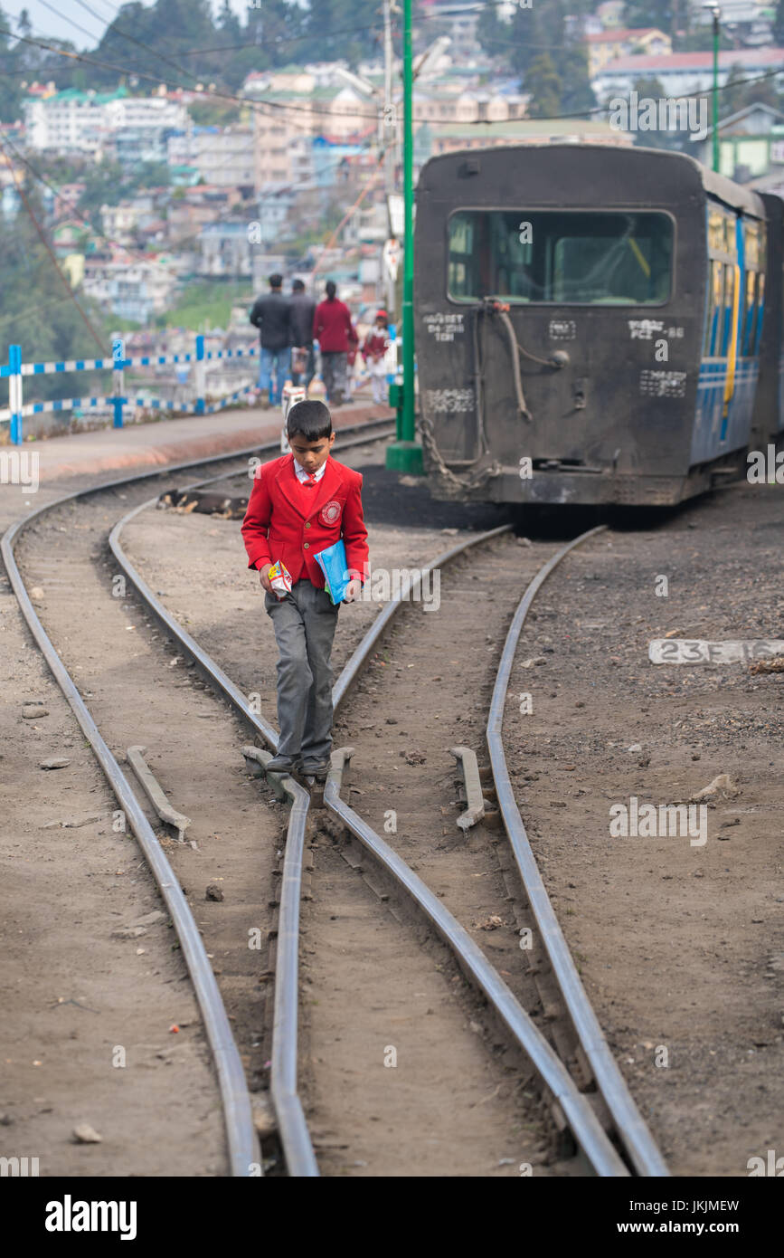 DARJEELING, INDIA - NOVEMBER 28, 2016: The Darjeeling Railway have railway near road and people area because of this city is on high attitude place. Stock Photo