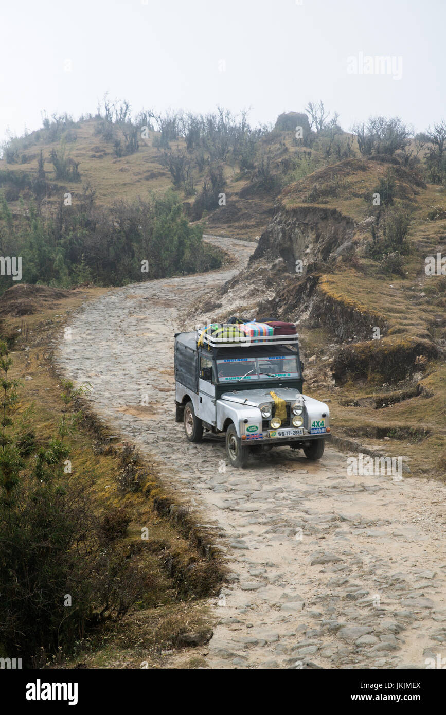 DARJEELING, INDIA - NOVEMBER 28, 2016: Jeep on gravel road through Singalila National Park. It is the route to Sankakphu and Phalut, the two highest p Stock Photo