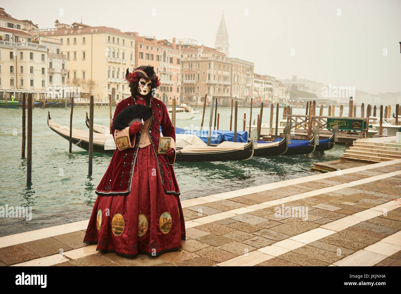 Female Mask wearer at the Carnival of Venice with red Coat and Red ...