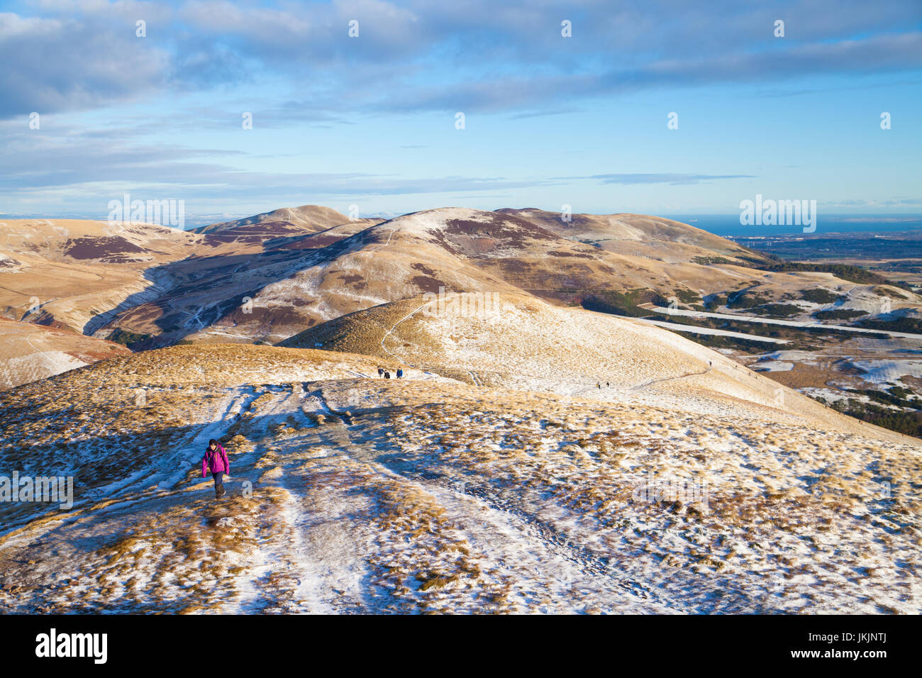 Walkers approaching the summit of Carnethy Hill in the Pentland Hills near Edinburgh. Stock Photo