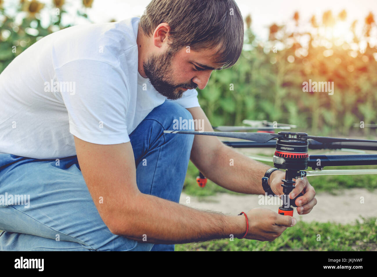 Young engineer preparing surveillance drone in field Stock Photo - Alamy