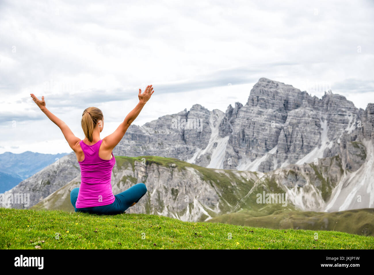 young woman meditate on top of the mountain Stock Photo - Alamy