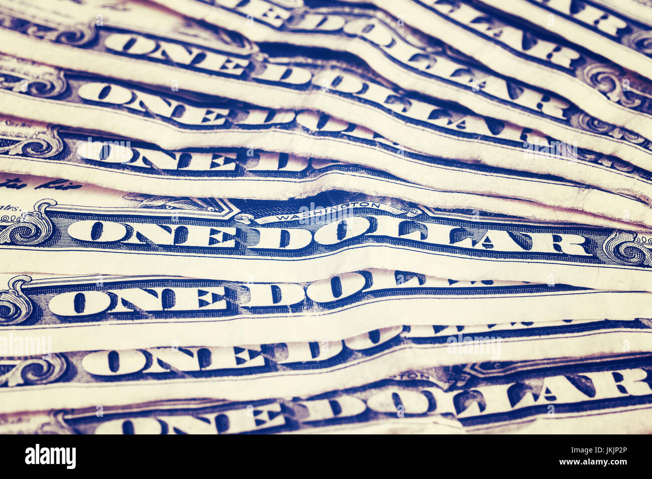 Close up of old one dollar bills, shallow depth of field, color toning applied. Stock Photo