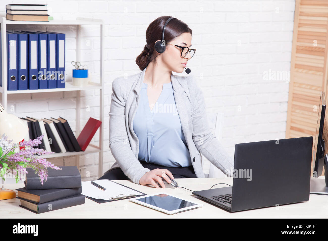 Call Center operator works at the computer in the Office Stock Photo