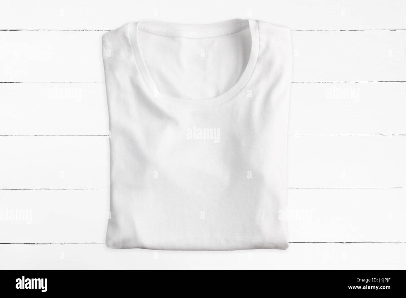 Blank folded t-shirt on white wooden background Stock Photo
