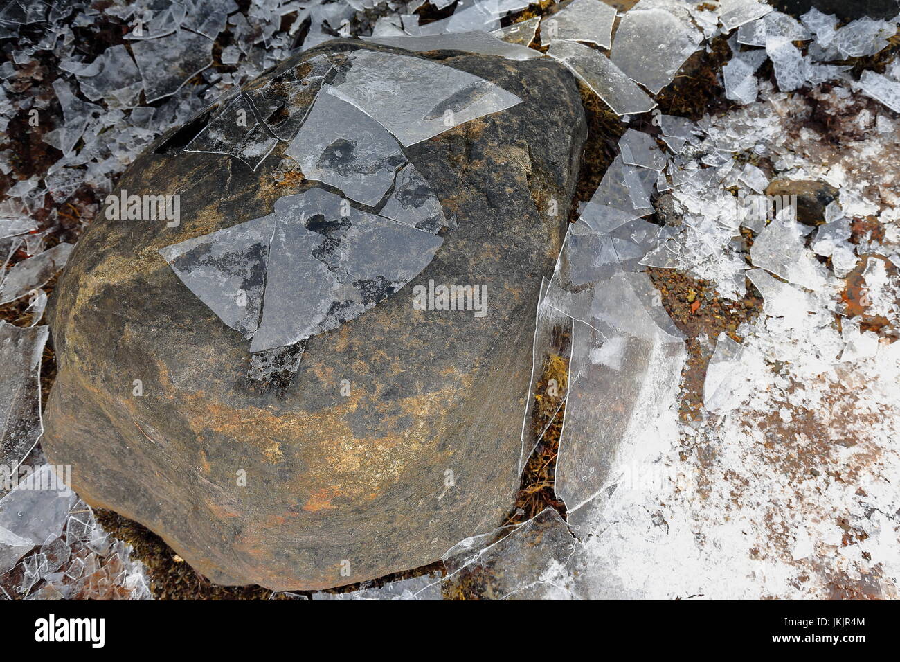Detail of brittle ice smashed on the floor-stone at the bottom of small cove in Sildpolltjonna bay-S.shore Sildpollnes peninsula-Austnesfjorden. Vagan Stock Photo