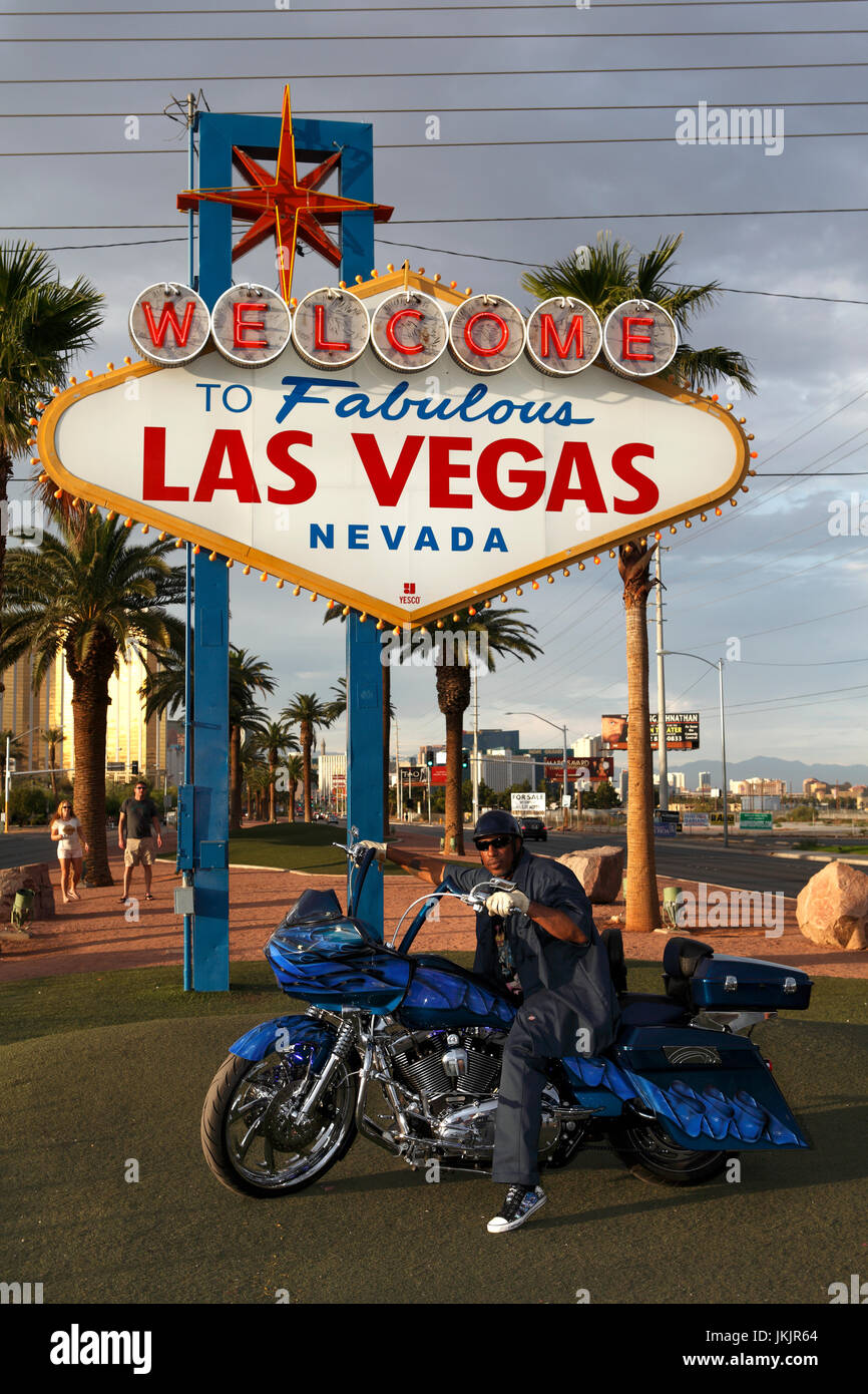 Man and his Harley Davidson motorcycle at Welcome to Las Vegas sign. Stock Photo