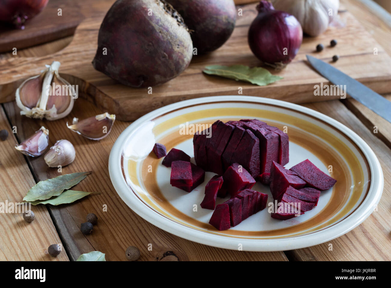 Sliced red beets on a plate, spices and other ingredients for beet kvass (fermented beets) Stock Photo