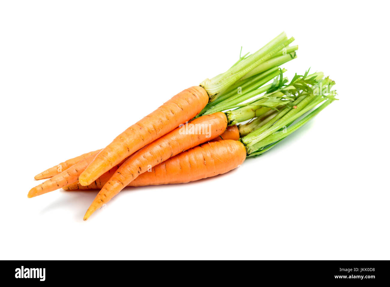 Heap of fresh carrots with stems isolated on white background Stock Photo