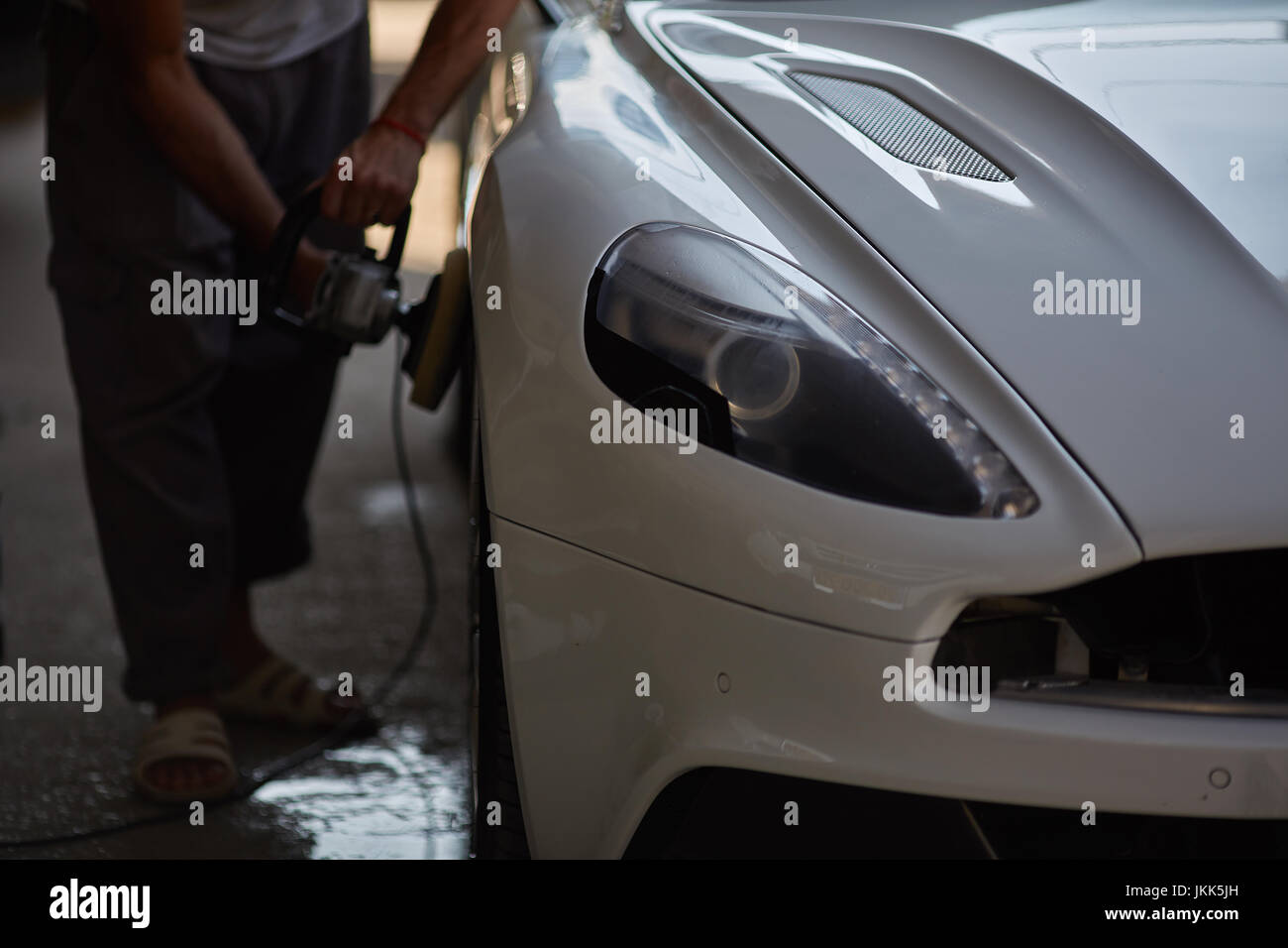 Car polishing series Worker waxing white car door Stock Photo Alamy