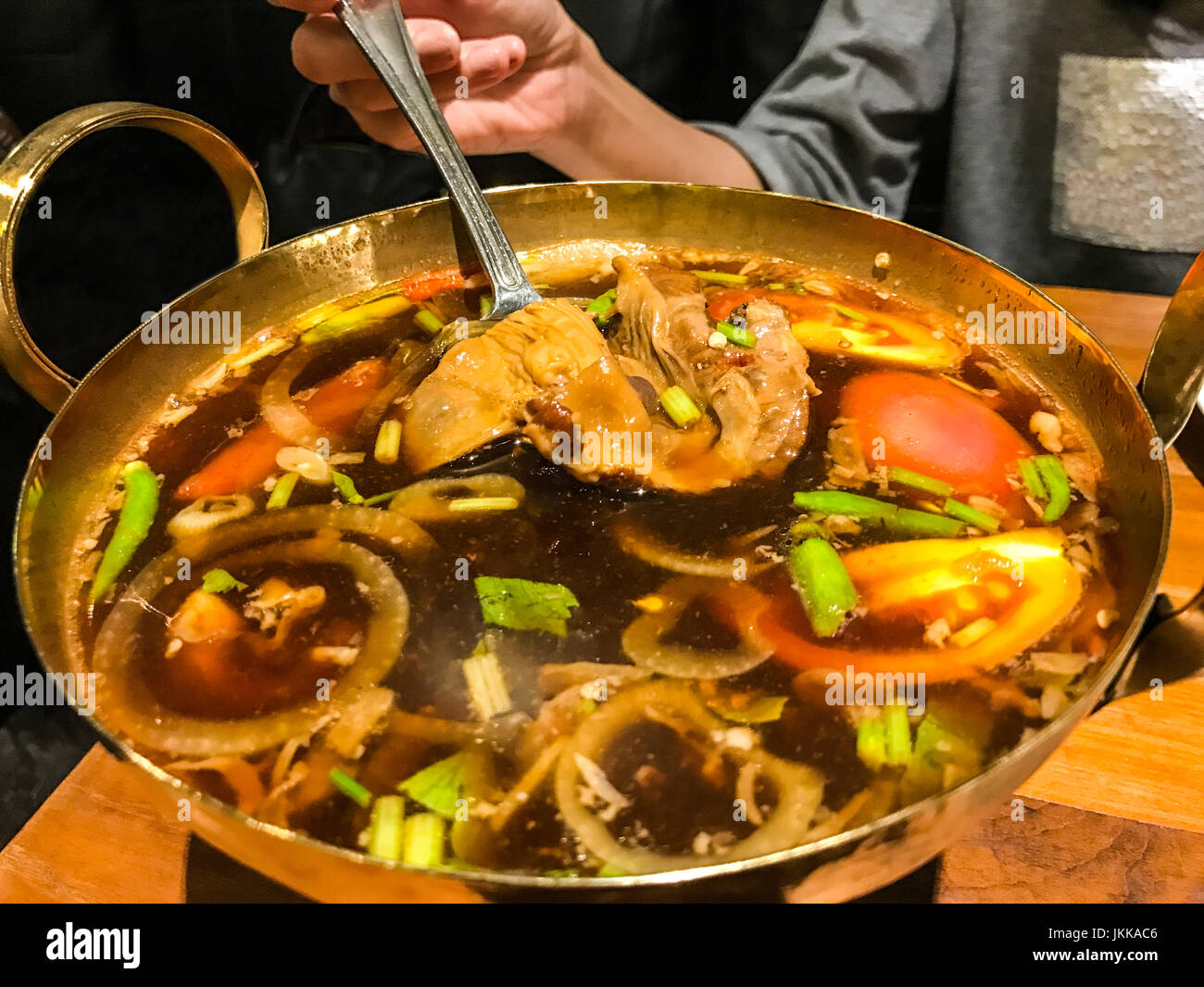 Traditional authentic Thai herbal soup food in brass hot pot Hot and