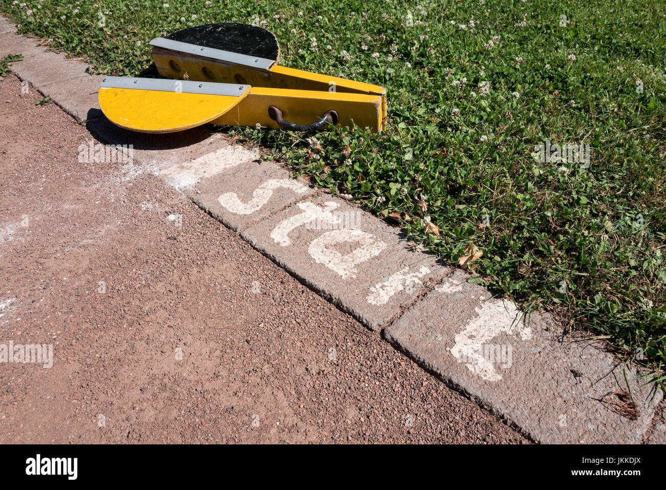 starting clapper at start point of cinder track Stock Photo Alamy