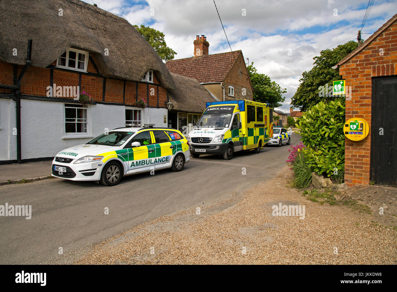 A police car and ambulance parked outside a pub in West Hanney, Wantage, Oxfordshire, UK. Stock Photo