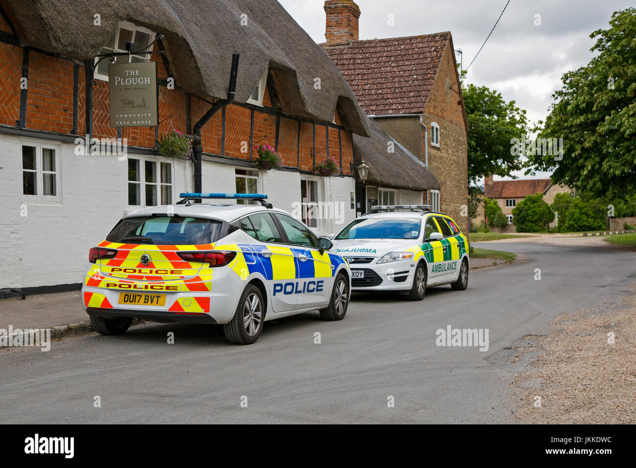 A police car and ambulance parked outside a pub in West Hanney, Wantage, Oxfordshire, UK. Stock Photo
