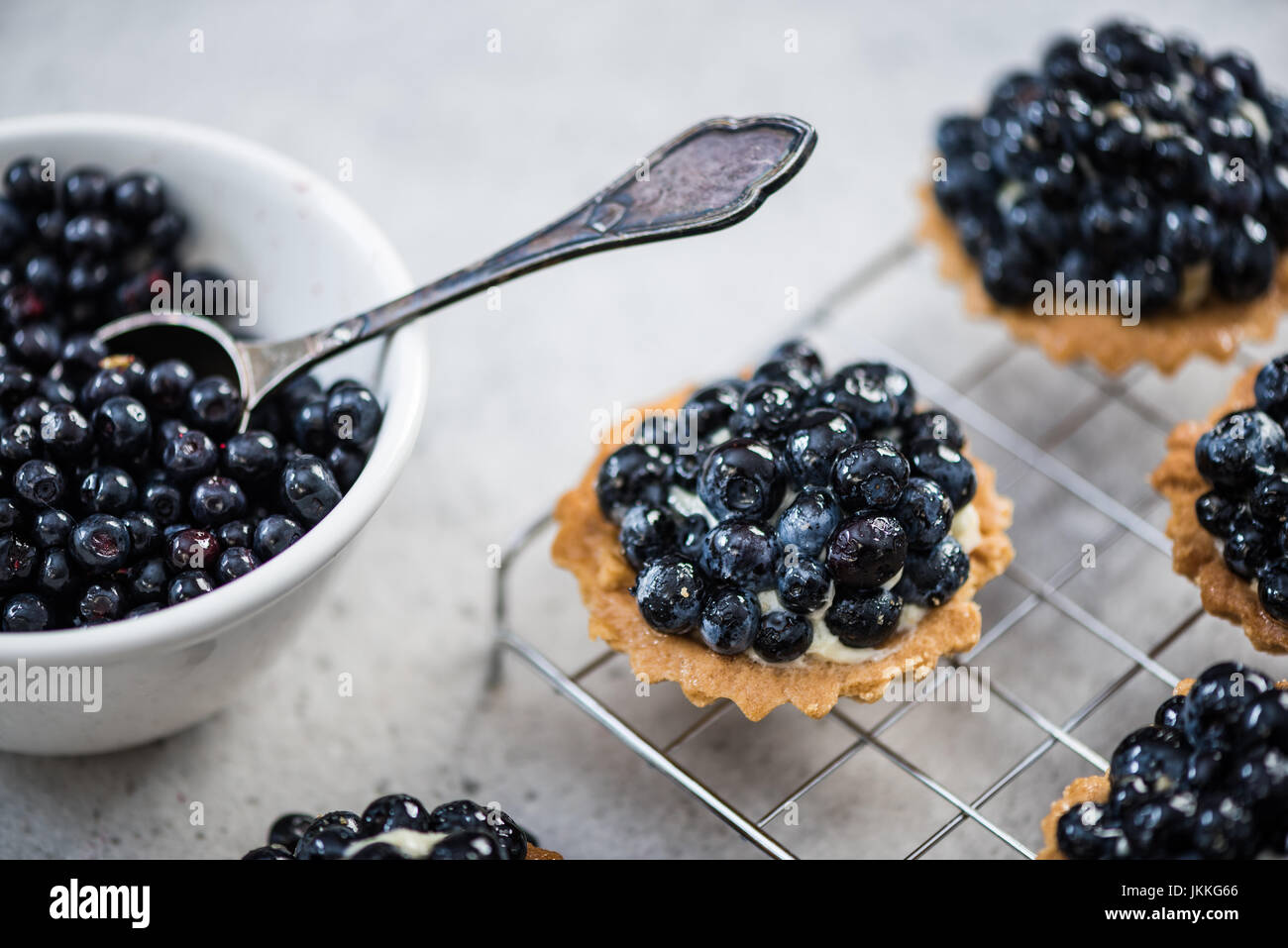 Blueberry tart pie on concrete slate, making and ingredients concept. Stock Photo