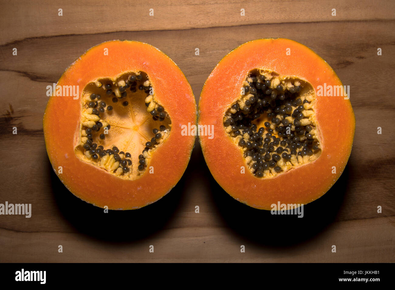 Ripe papaya fruit cut in half looking a both sides Stock Photo Alamy