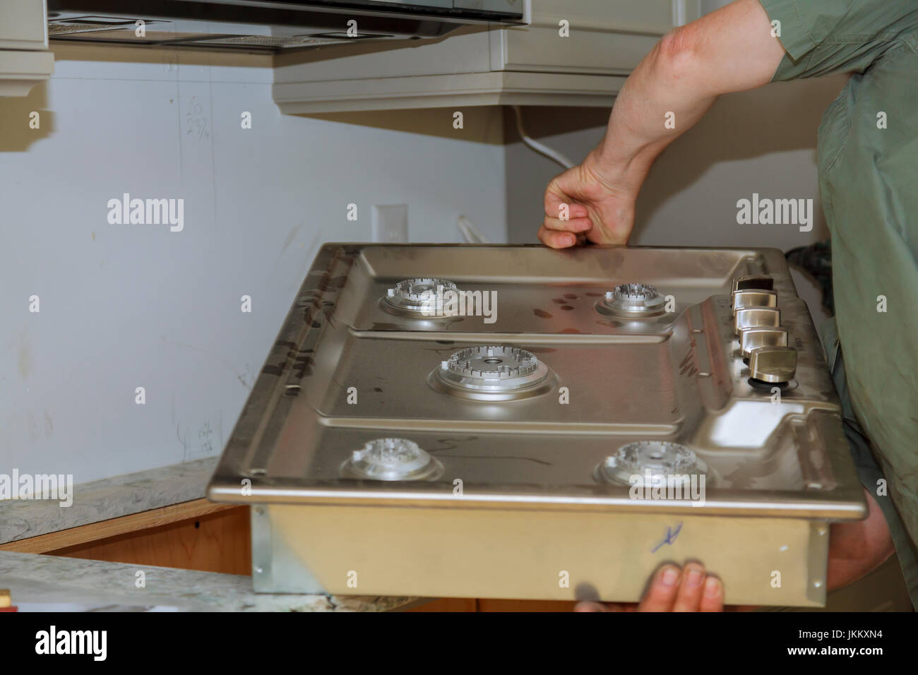 A gas cooker built in a kitchen table. The master installs a gas oven in a new building Stock