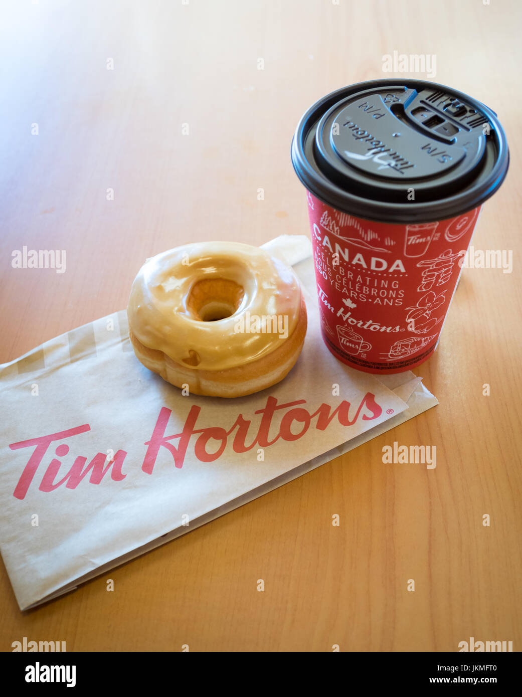 A Tim Hortons maple dip donut and coffee. Stock Photo