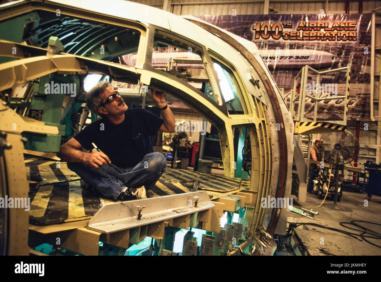Skilled aerospace workers build a commercial Boeing 737 aircraft. Stock Photo