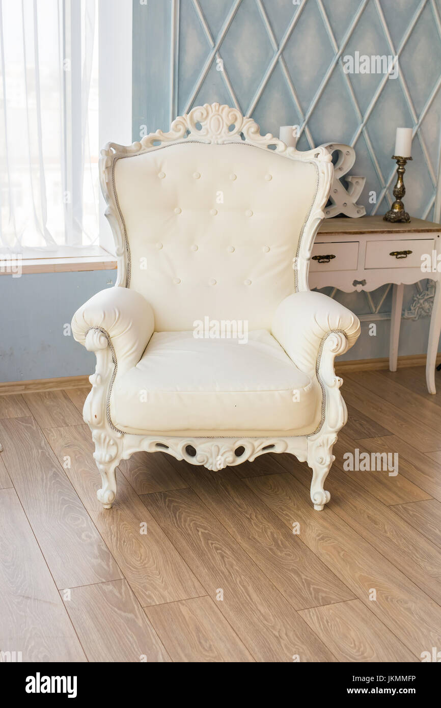 luxury armchair in a plain white interior Stock Photo - Alamy