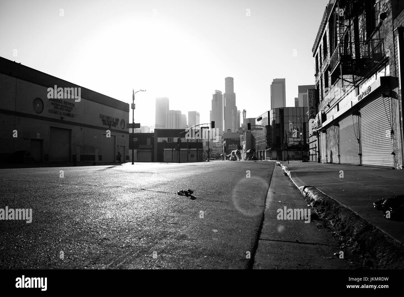 Black and white image of a deserted Los Angeles road from street level, taken around sunset. Stock Photo