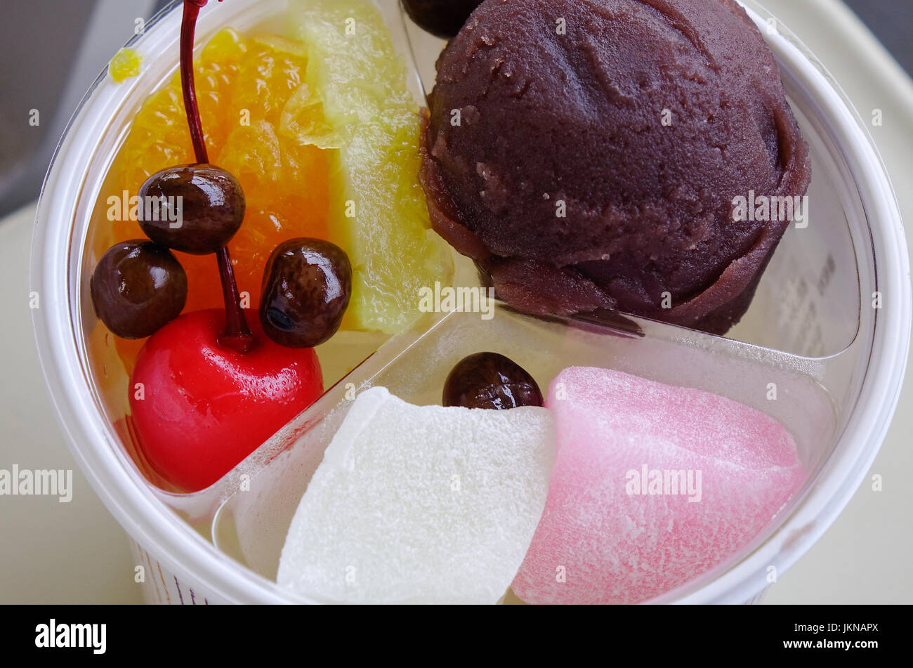 Sweet Japanesestyle cakes with fruits and cream. Close up Stock Photo