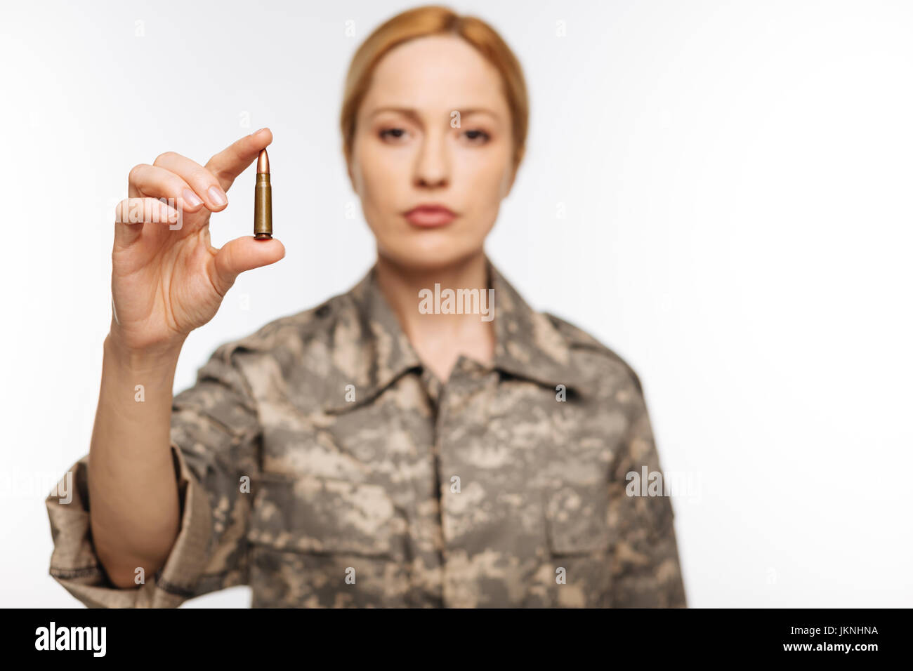 Fearless confident woman showing a bullet Stock Photo