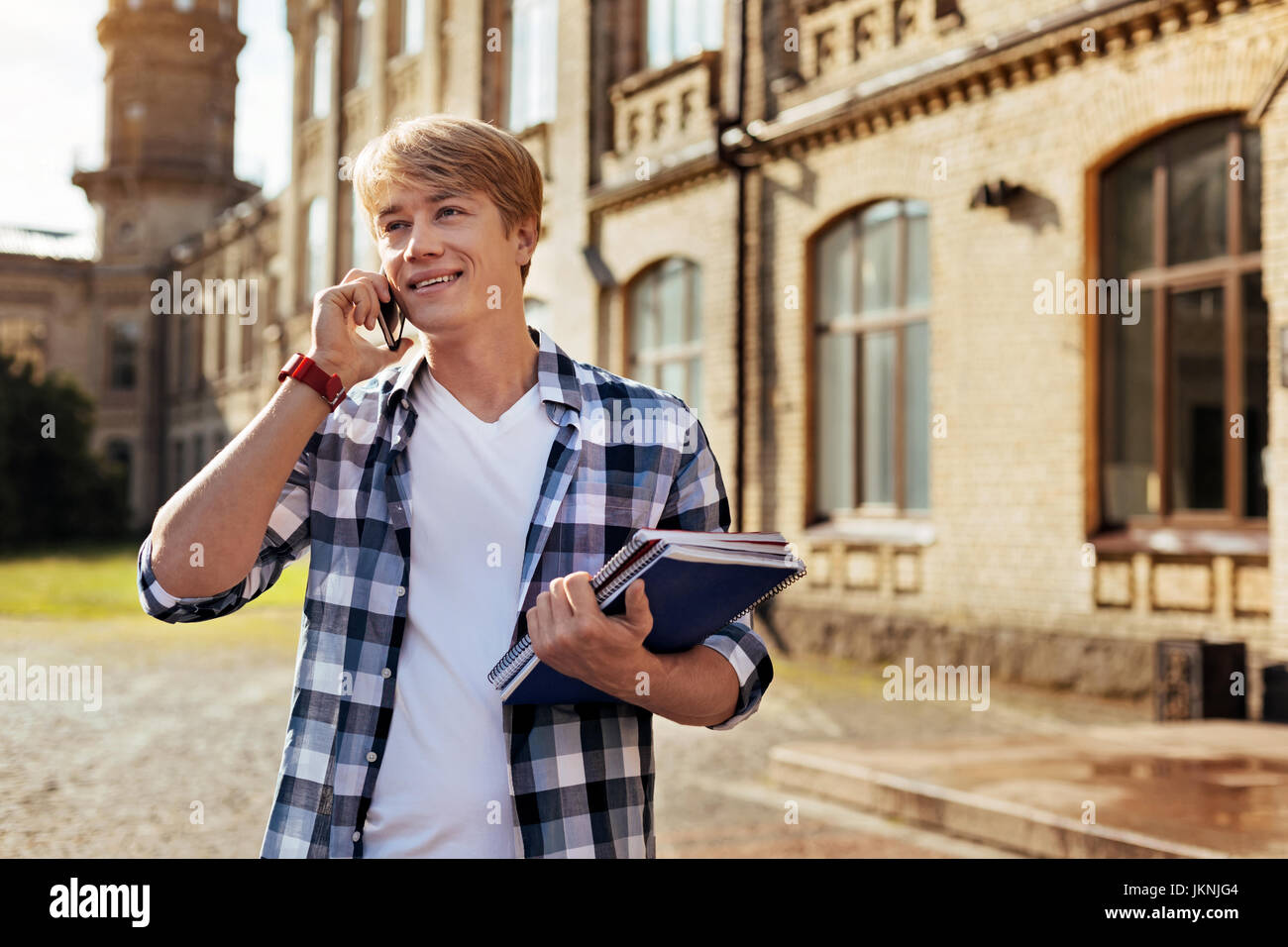 Confident easygoing man calling his friend Stock Photo
