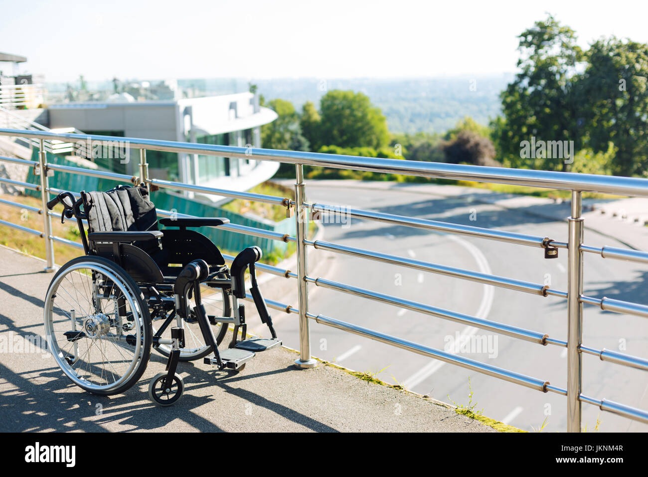 Black new wheelchair left on a terrace Stock Photo