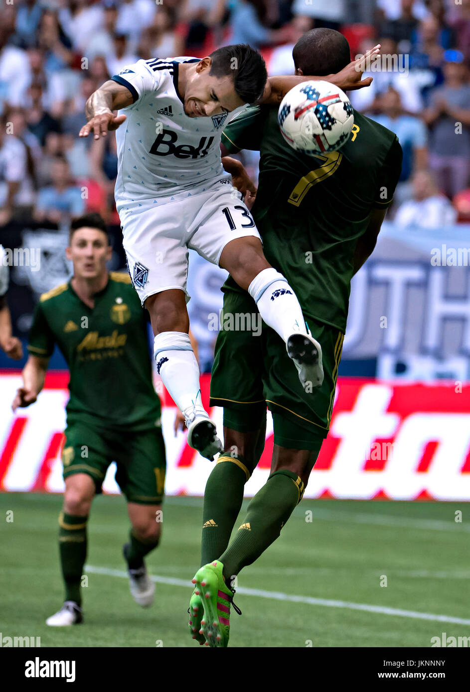 Vancouver, Canada. 23rd July, 2017. Cristian Techera (C) of Vancouver Whitecaps heads the ball with Roy Miller (R) of Portland Timbers during the 2017 Major League Soccer (MLS) match between Portland Timbers and Vancouver Whitecaps at BC Place Stadium in Vancouver, Canada, on July 23, 2017. Portland Timbers won 2-1. Credit: Andrew Soong/Xinhua/Alamy Live News Stock Photo