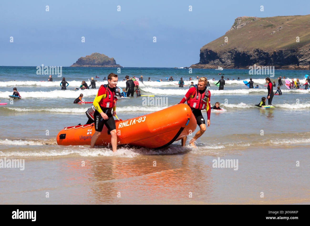 Polzeath, Cornwall, UK. 24th July 2017.  It's the first full week of the school summer holidays and RNLI lifeguards patrol the beach on a warm sunny day in Polzeath, North Cornwall. Credit: Mark Richardson/17�Թ����� Live News Stock Photo