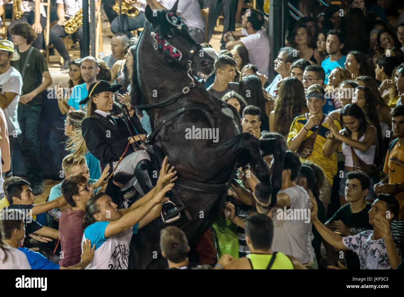 Es Castell, Spain. 24 July, 2017:  A 'caixer' (horse rider) rears up on his horse surrounded by a cheering crowd during the 'Jaleo' of the traditional 'Sant Jaume' (Saint James) festival in Es Castell, the town's patron saint fiesta Credit: Matthias Oesterle/Alamy Live News Stock Photo