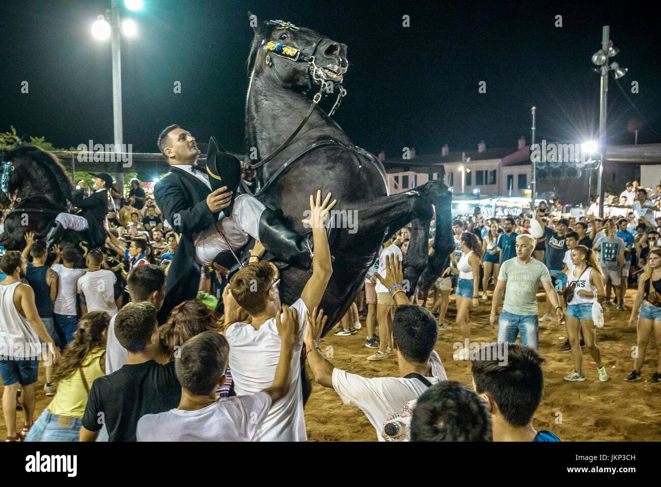 Es Castell, Spain. 24 July, 2017:  A 'caixer' (horse rider) rears up on his horse surrounded by a cheering crowd during the 'Jaleo' of the traditional 'Sant Jaume' (Saint James) festival in Es Castell, the town's patron saint fiesta Credit: Matthias Oesterle/Alamy Live News Stock Photo
