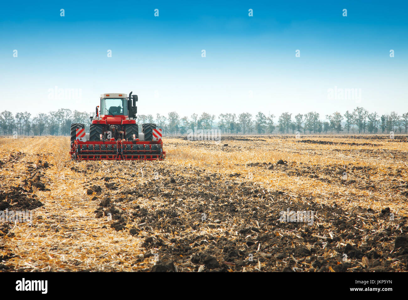 Modern tractor in the field with complex for the plowing. The concept ...