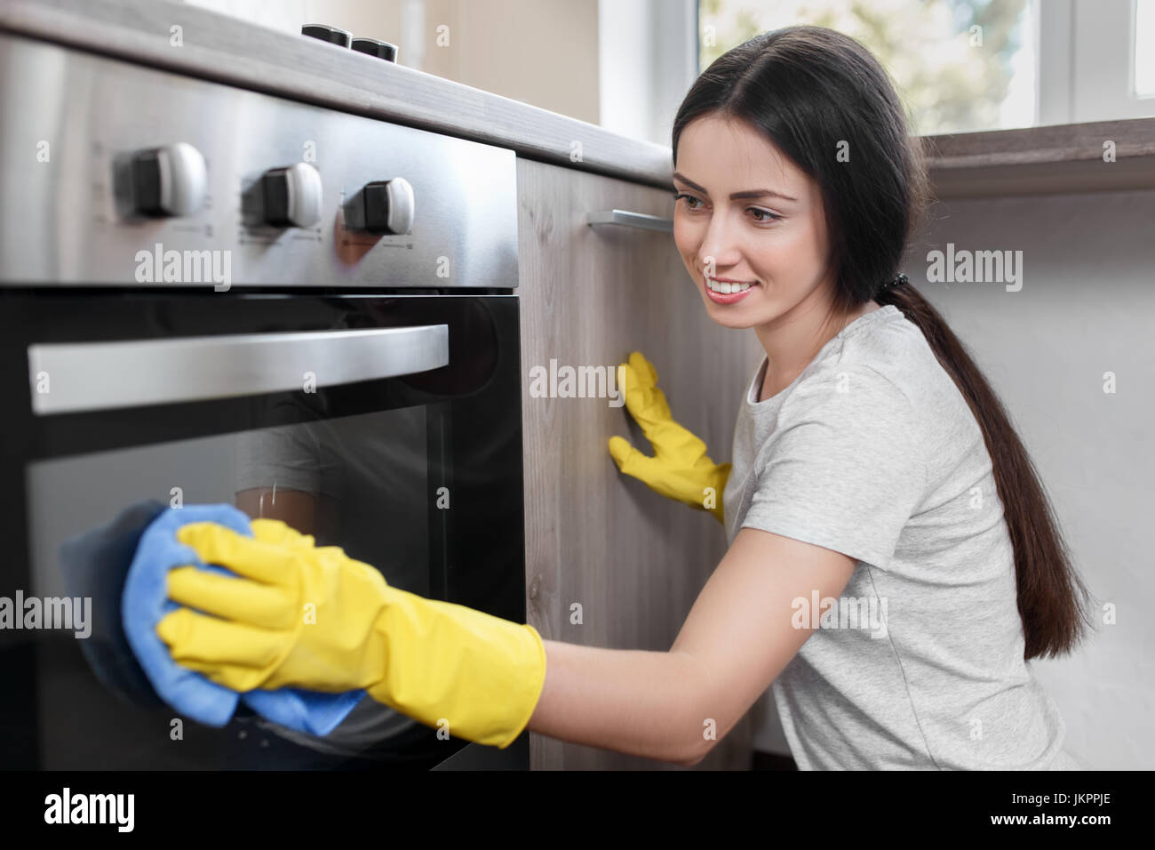 woman polishing oven Stock Photo