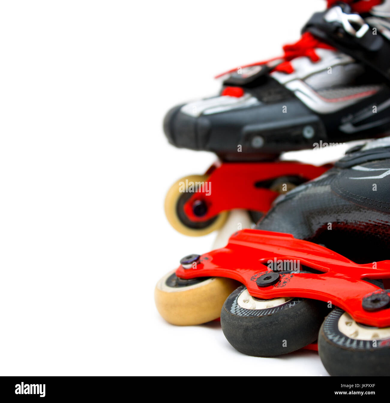Inline roller skates close up isolated on white background with blur. Vertical copy-space. Stock Photo