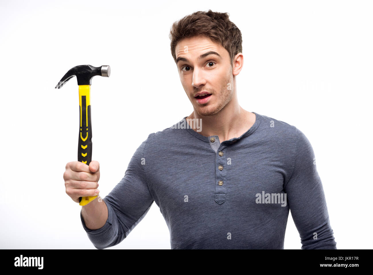 handsome man holding hammer isolated on white, handyman tools concept Stock Photo