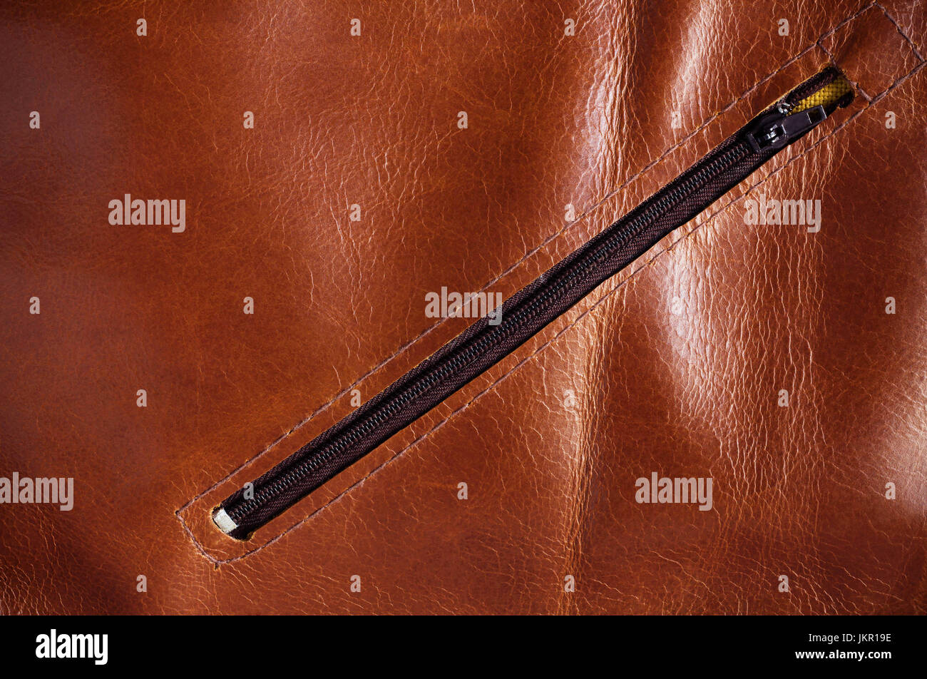 surface and zipper on the leather plate. Stock Photo