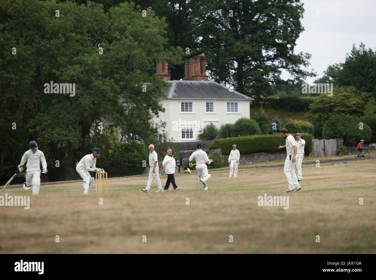 A village cricket match between Tilford and Grayswood being played at Tilford Green in Waverley, Surrey. Stock Photo